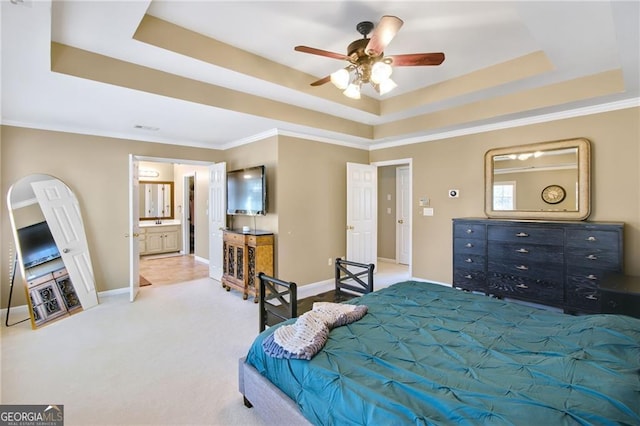 bedroom featuring ceiling fan, a raised ceiling, carpet floors, and ensuite bathroom