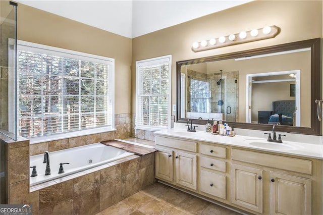 bathroom with plenty of natural light, vanity, independent shower and bath, and tile patterned flooring