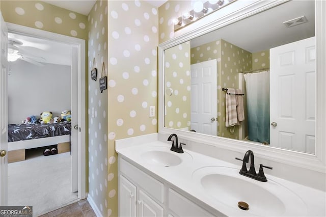 bathroom featuring walk in shower, vanity, and ceiling fan