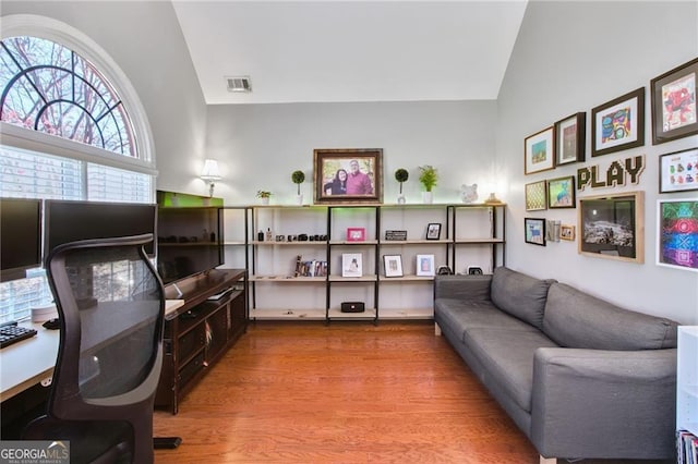 home office featuring hardwood / wood-style flooring and lofted ceiling