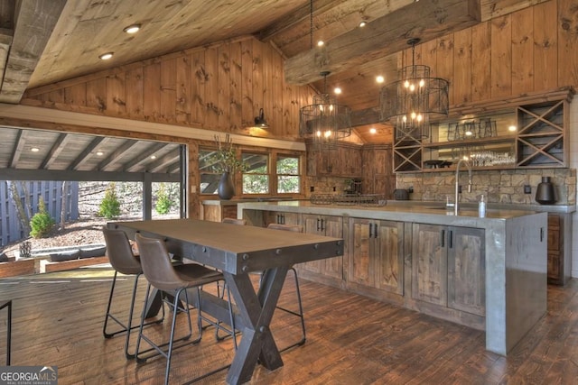 interior space with wood walls, beam ceiling, wood ceiling, and dark wood-type flooring