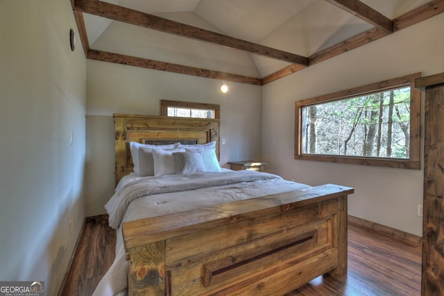 bedroom with lofted ceiling with beams, dark hardwood / wood-style floors, and multiple windows