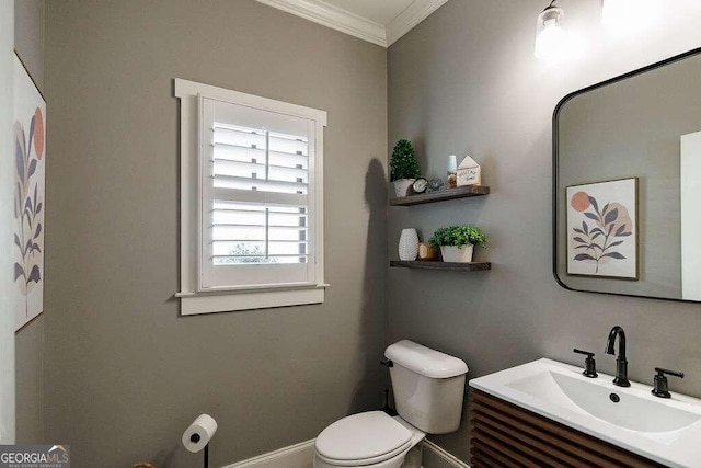 bathroom featuring vanity, toilet, and crown molding