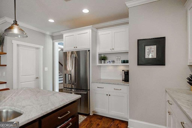 kitchen featuring light stone countertops, stainless steel refrigerator with ice dispenser, tasteful backsplash, and white cabinetry