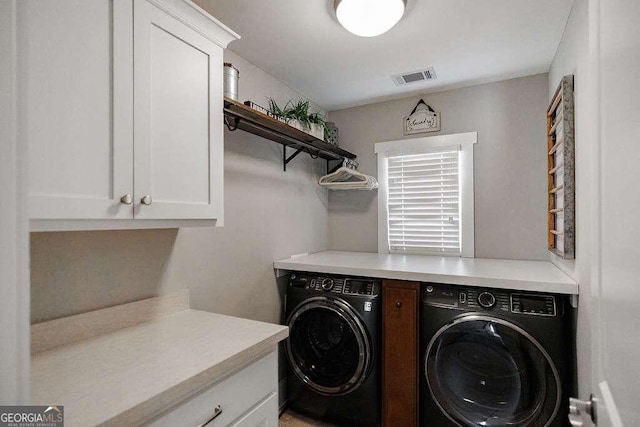 laundry area with cabinets and washing machine and dryer