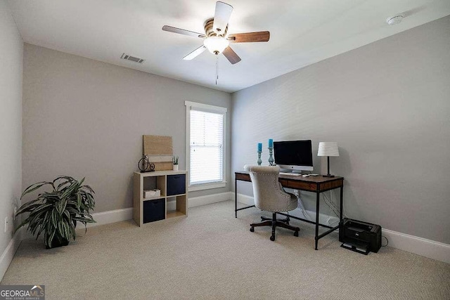 carpeted home office with ceiling fan