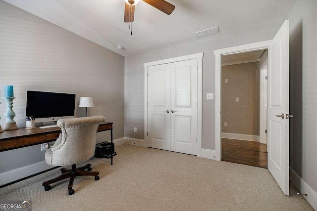 office area featuring ceiling fan, light colored carpet, and ornamental molding