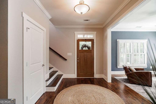 entrance foyer featuring dark wood-type flooring and ornamental molding