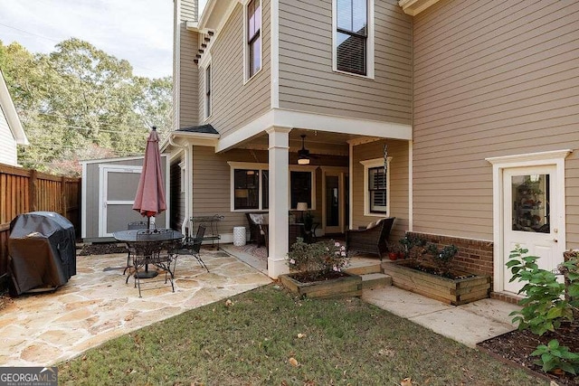 view of patio with area for grilling and a shed