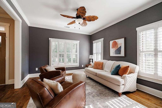 living room with crown molding, hardwood / wood-style floors, and ceiling fan