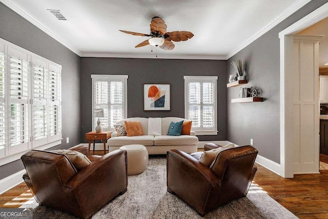 living room with plenty of natural light, hardwood / wood-style floors, and ornamental molding