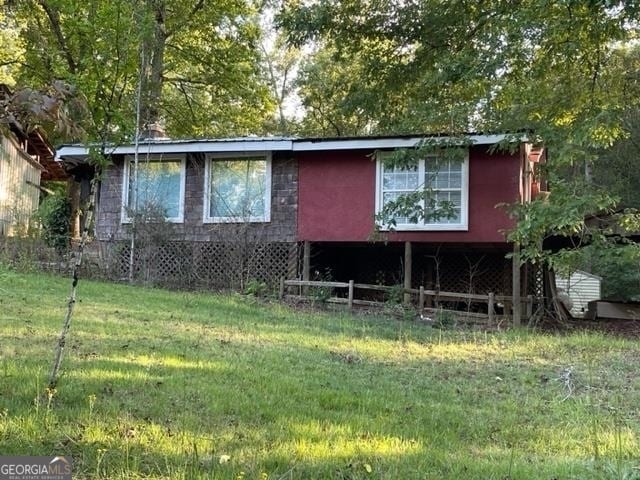 rear view of property featuring a yard