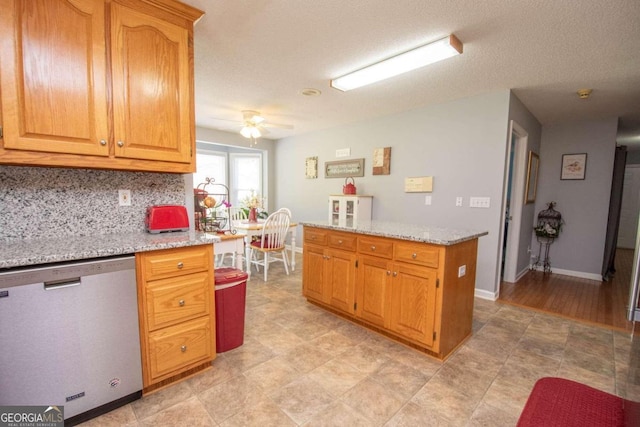 611 Bernhard Rd, Fayetteville, GA 30215 - kitchen featuring stainless steel dishwasher, backsplash, ceiling fan, and light stone counters