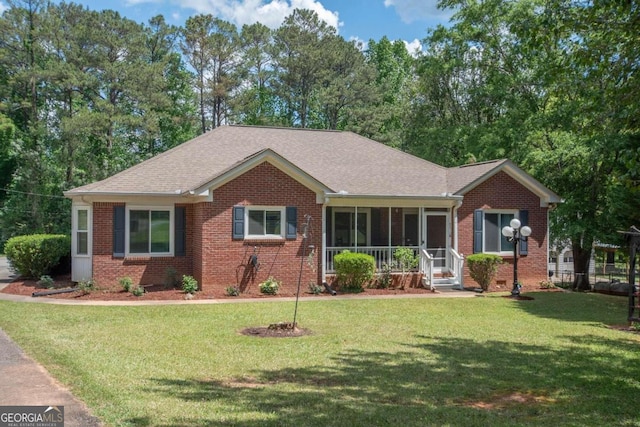 611 Bernhard Rd, Fayetteville, GA 30215 - single story home with brick siding, a sunroom, a front yard, and roof with shingles