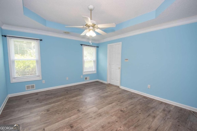 611 Bernhard Rd, Fayetteville, GA 30215 - empty room featuring wood finished floors, ceiling fan, a tray ceiling, and ornamental molding