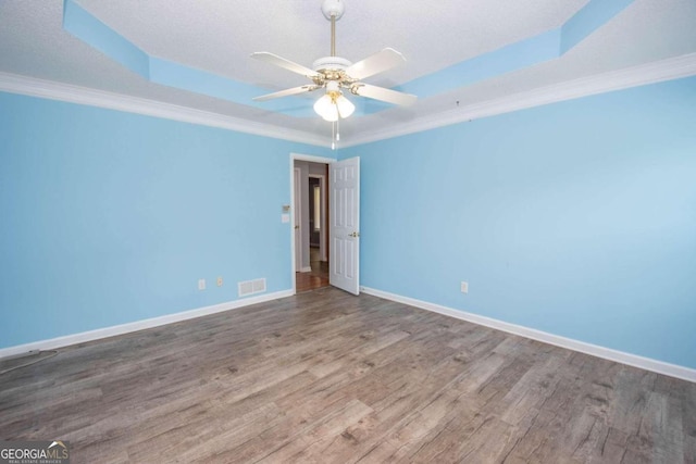 611 Bernhard Rd, Fayetteville, GA 30215 - spare room featuring wood finished floors, a ceiling fan, a raised ceiling, and crown molding