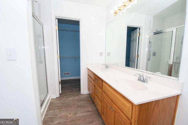 611 Bernhard Rd, Fayetteville, GA 30215 - full bath with a shower stall, wood finished floors, double vanity, and a spacious closet