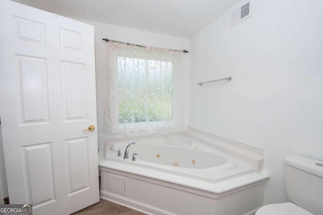 611 Bernhard Rd, Fayetteville, GA 30215 - bathroom featuring a jetted tub and wood finished floors