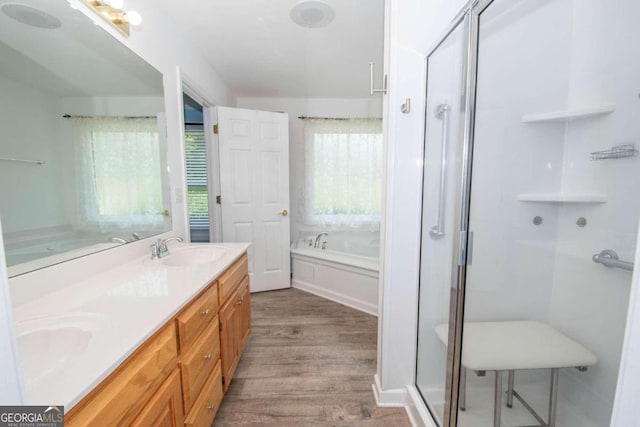 611 Bernhard Rd, Fayetteville, GA 30215 - bathroom with wood finished floors, a bath, double vanity, and a stall shower