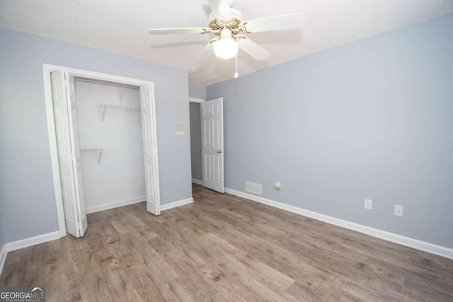 611 Bernhard Rd, Fayetteville, GA 30215 - unfurnished bedroom featuring wood finished floors, a closet, and ceiling fan
