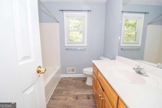 611 Bernhard Rd, Fayetteville, GA 30215 - bathroom with plenty of natural light, vanity, wood finished floors, and bathing tub / shower combination