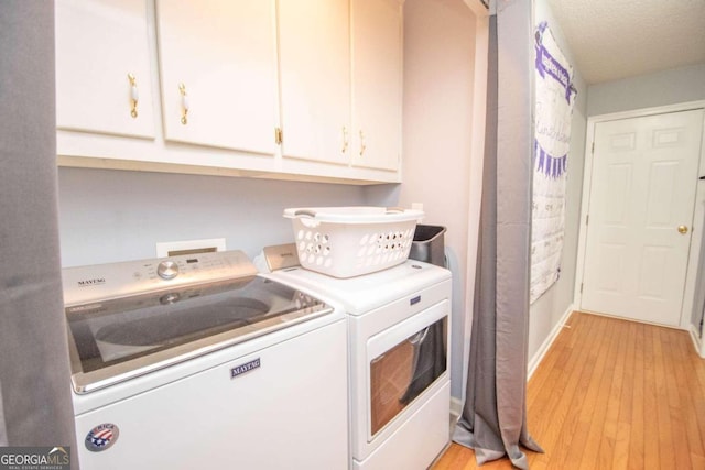 611 Bernhard Rd, Fayetteville, GA 30215 - laundry room with separate washer and dryer, cabinet space, and light wood-type flooring