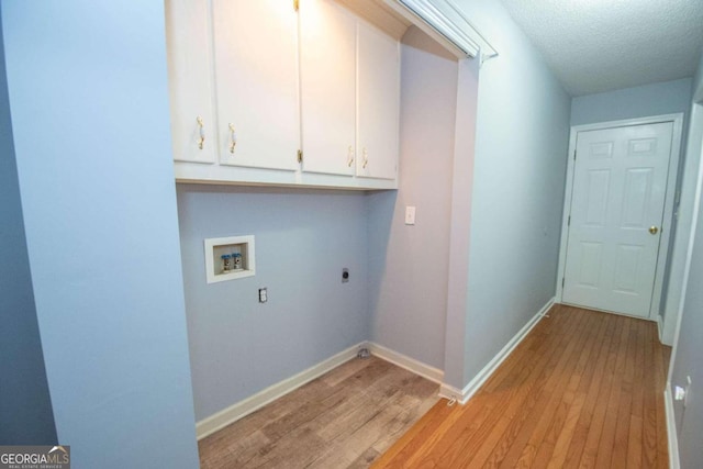 611 Bernhard Rd, Fayetteville, GA 30215 - washroom with cabinet space, electric dryer hookup, light wood finished floors, hookup for a washing machine, and a textured ceiling