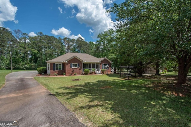 611 Bernhard Rd, Fayetteville, GA 30215 - ranch-style house featuring brick siding, a front lawn, asphalt driveway, and view of wooded area