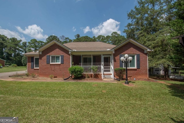 611 Bernhard Rd, Fayetteville, GA 30215 - view of front facade with a front lawn, brick siding, and a sunroom