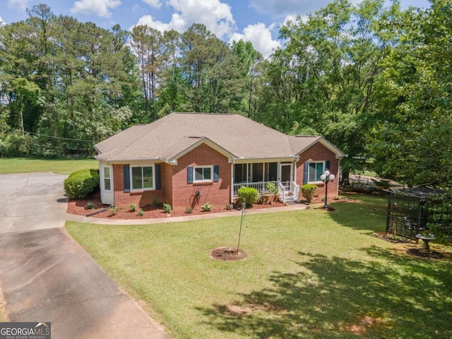 611 Bernhard Rd, Fayetteville, GA 30215 - ranch-style house with brick siding, concrete driveway, and a front yard