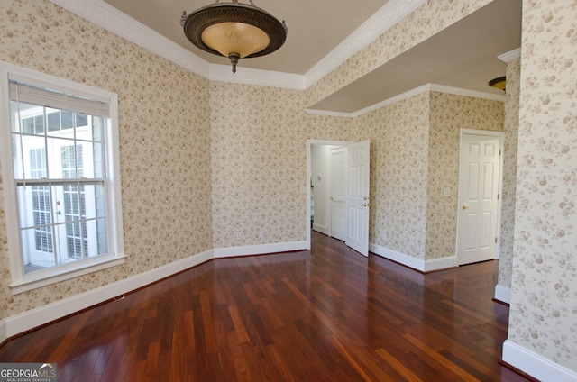 unfurnished room with ornamental molding and dark wood-type flooring