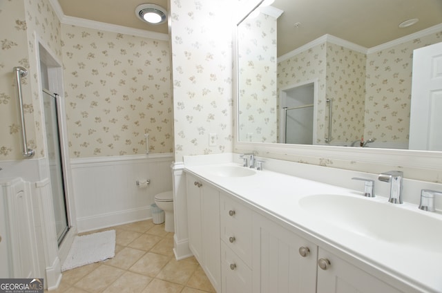 bathroom featuring vanity, crown molding, tile patterned flooring, toilet, and a shower with shower door