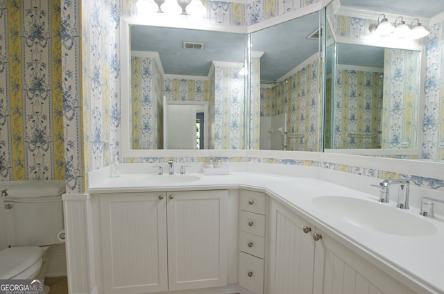 bathroom with toilet, vanity, a shower with shower curtain, and ornamental molding