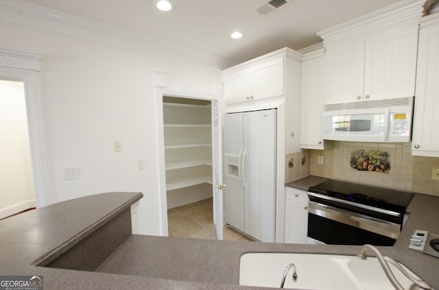 kitchen with decorative backsplash, white appliances, white cabinetry, and crown molding