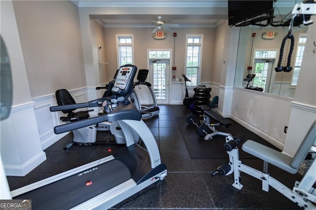 gym featuring ceiling fan, crown molding, and a wealth of natural light