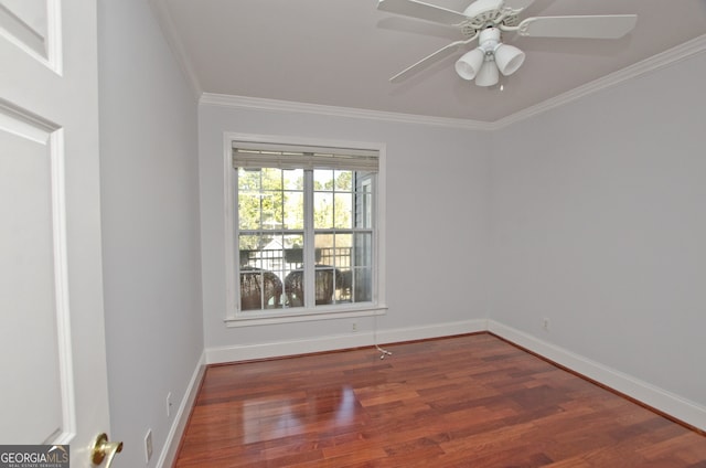 spare room featuring crown molding, ceiling fan, and dark wood-type flooring