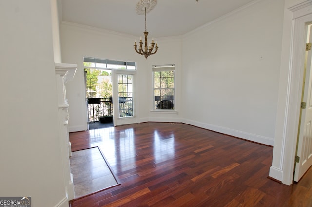 unfurnished dining area with crown molding, dark hardwood / wood-style flooring, and a chandelier