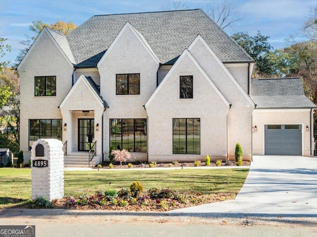 view of front of property featuring a garage and a front lawn