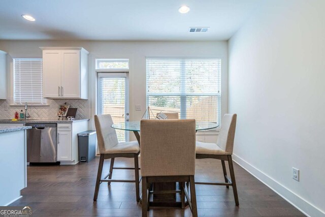 dining room featuring dark wood-type flooring and sink