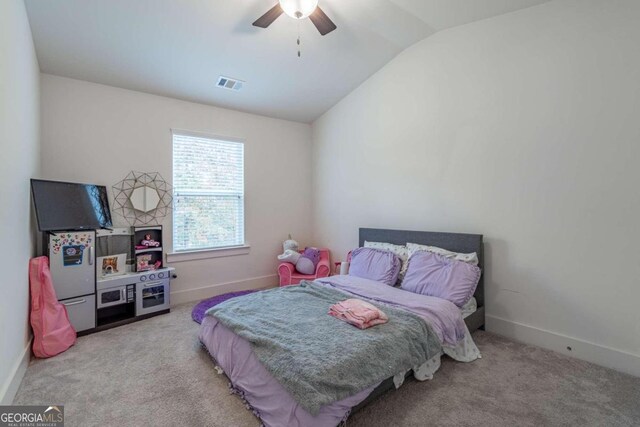 carpeted bedroom featuring ceiling fan and vaulted ceiling