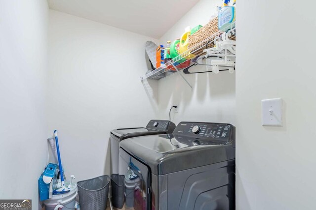 clothes washing area featuring washer and clothes dryer