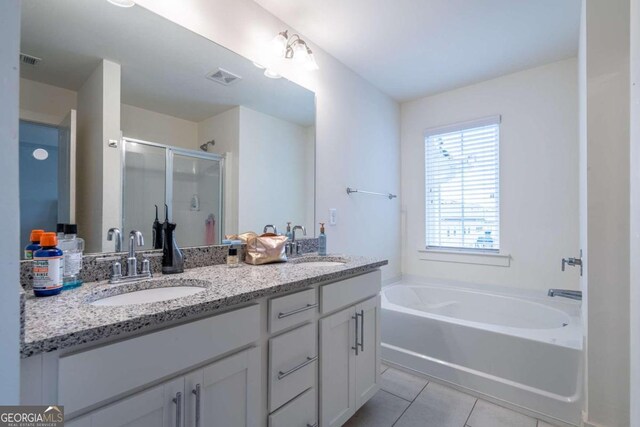 bathroom with plus walk in shower, tile patterned flooring, and vanity