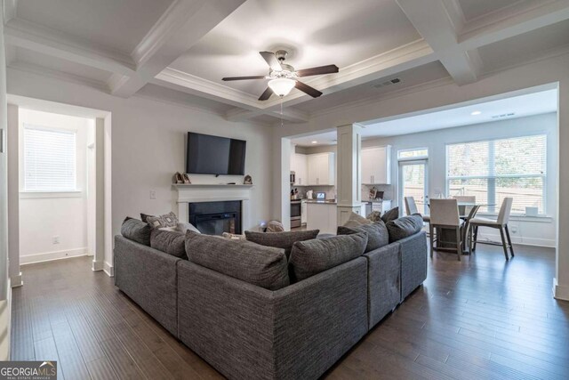 living room featuring beamed ceiling, dark hardwood / wood-style flooring, and coffered ceiling