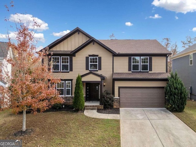 view of front of property featuring a garage and a front lawn