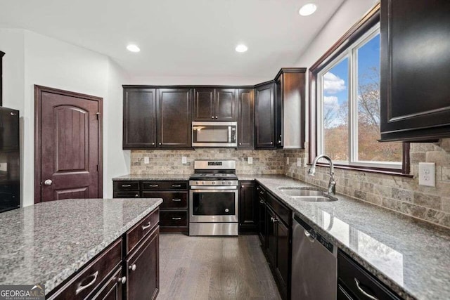 904 Berry Ct, Canton, GA 30114 - kitchen with dark hardwood / wood-style floors, light stone countertops, sink, and appliances with stainless steel finishes