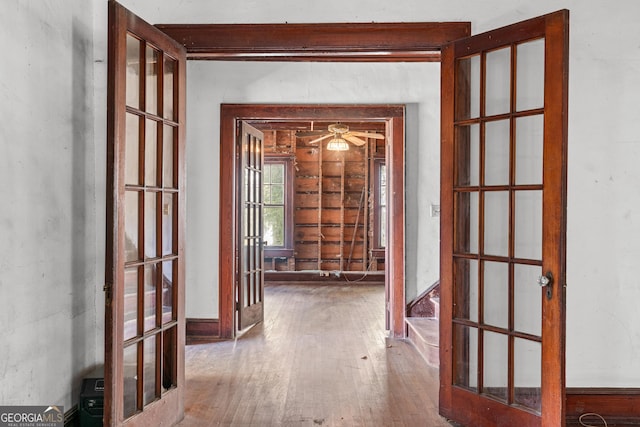 hallway with french doors and wood-type flooring