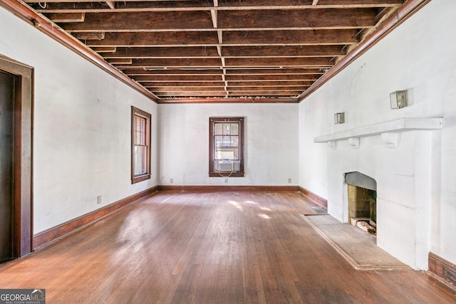 unfurnished living room featuring hardwood / wood-style floors and cooling unit