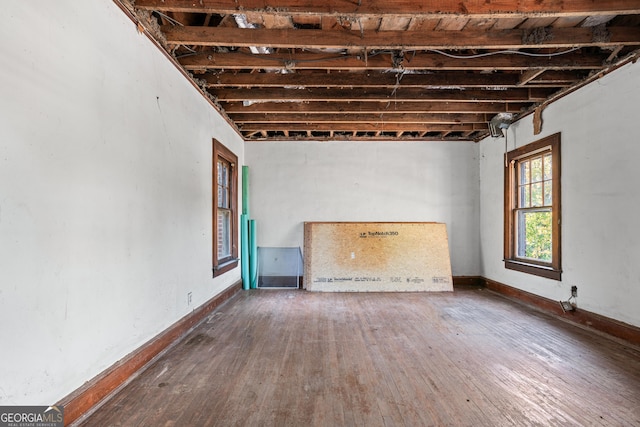 basement with hardwood / wood-style floors