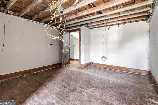 basement with dark hardwood / wood-style flooring and wood ceiling