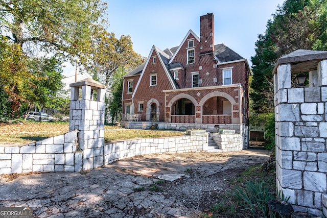 back of property featuring covered porch